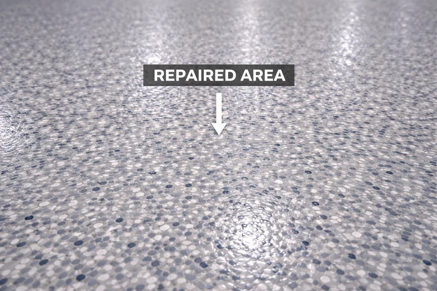 Color-matched epoxy floor repair showing seamless repaired area blended into existing decorative flake coating